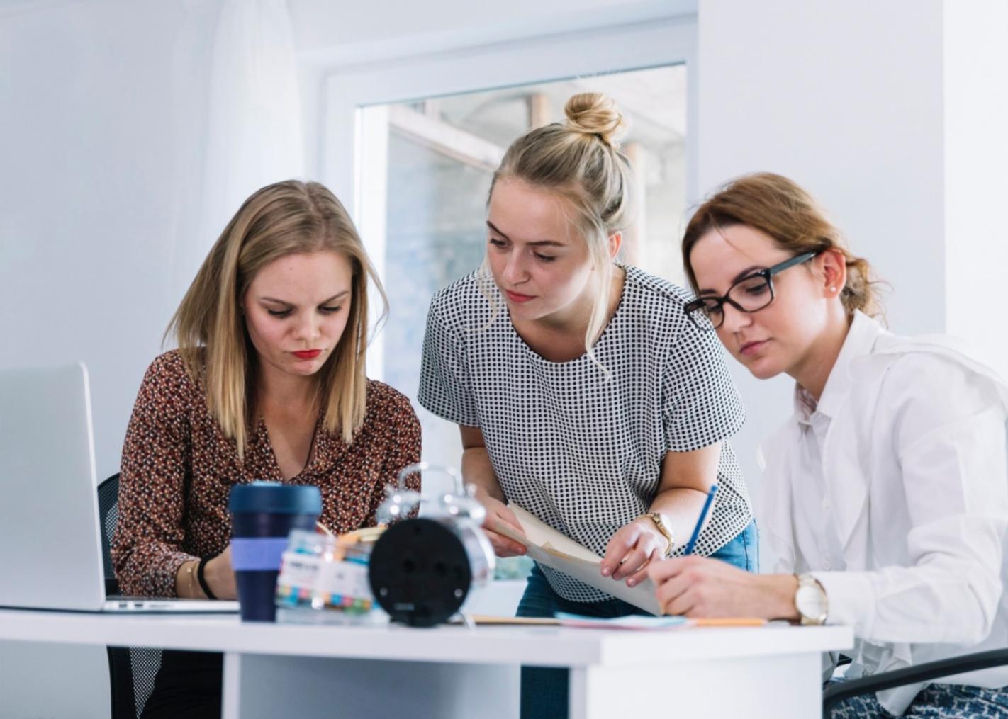 Financial professionals working together on seasonal budget planning strategies in a modern training environment
